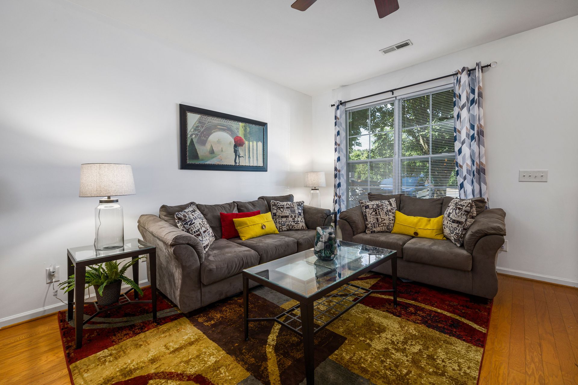 Elegant living room interior featuring a glass coffee table, comfortable sofas, and stylish decor for a cozy ambiance.